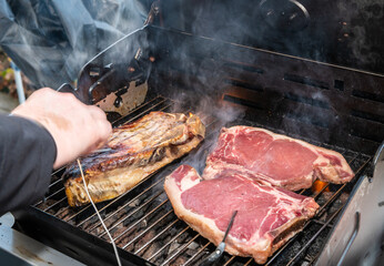 grilled t-bone Steak ( beef stead) on a barbecue with meat thermometer. Selective focus