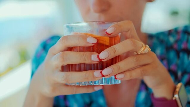 female sipping alcohol negroni cocktail