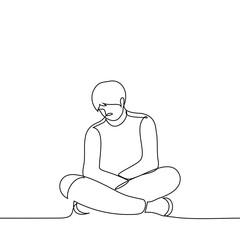 man is sitting on the floor with legs and arms crossed and head down - one line drawing vector. concept sad man sitting in a closed pose
