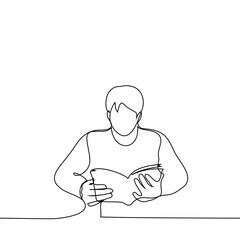 man is sitting at a table with a paperback book - one line drawing vector. book lover concept, reader in library, student with textbook