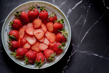 Fresh Organic Strawberries on a dark granite surface