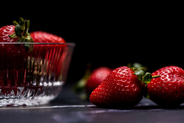 Fresh Organic Strawberries on a dark granite surface