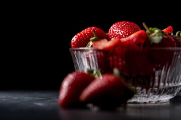 Fresh Organic Strawberries on a dark granite surface