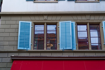 Close-up of windows with blue wooden shutters at medieval old town of City of Zürich on a sunny autumn day. Photo taken October 30th, 2022, Zurich, Switzerland.