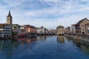 Scenic view over the old town of City of Zürich with Limmat River in the foreground on a blue cloudy autumn day. Photo taken October 30th, 2022, Zurich, Switzerland.