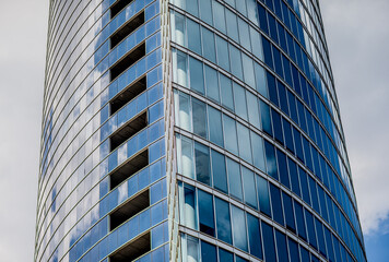 Fototapeta na wymiar Curved glass exterior on finance building skyscraper