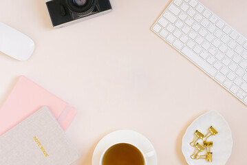 A minimalistic female workspace of a blogger or photographer Flat lay with a keyboard, pink and...