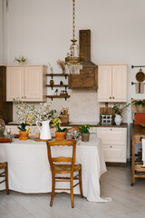 Rustic Scandinavian-style kitchen with spring flowers in the decor