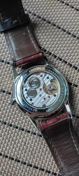 BANGKOK, THAILAND - DECEMBER 18 : Back case of Nomos Orion with brown alligator leather strap, show manual winding caliber with sapphire crystal case, in Bangkok, on December 18,  2022.