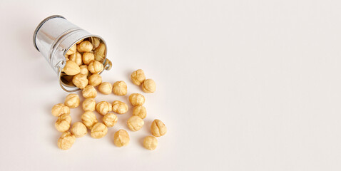 A metal bucket with scattered nuts. Nuts are a useful and nutritious product.