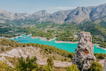 Artificial blue lagoon in the valley down the mountains in Spain