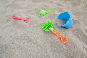 Fototapeta na wymiar Plastic beach toys on the sand of a beach