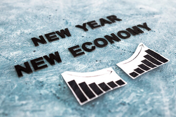 Naklejka premium new year new economy text with graphs showing growth stats going down then up again