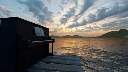 black piano in pier with beautiful sea view