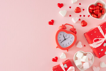 St Valentine's Day concept. Flat lay photo of red gift boxes, alarm clock, heart shaped saucers...