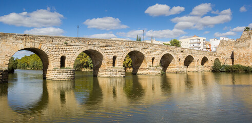 Panorama of the historic roman bridge (Puente Romana) over the Guadiana river in Merida, Spain - obrazy, fototapety, plakaty