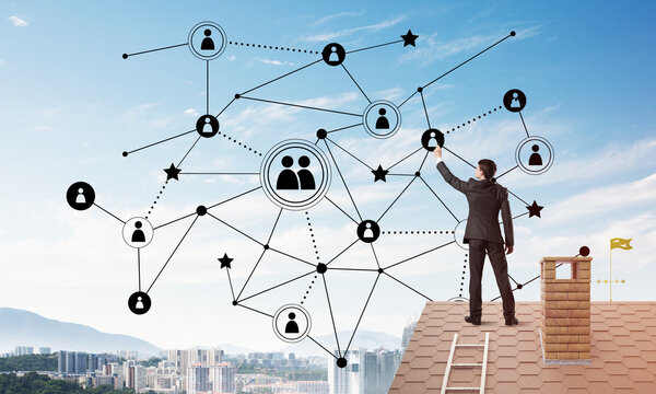 Businessman on house roof presenting networking and connection concept. Mixed media