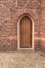 old wooden door in a brick wall