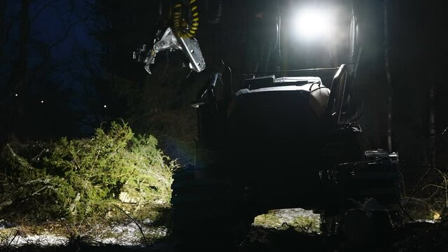 A look of the huge tree harvester on the forest about to get logs from the ground in Estonia