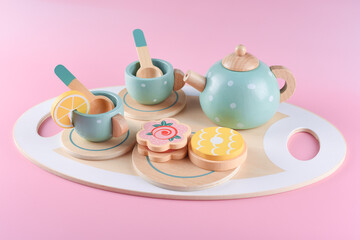Children's tea set, fake cake and biscuit, wooden kitchenware. Cute kids toys to play in the kitchen, blue cups with teapot. Educational toys, wooden play set