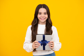 Emotional teenager child hold gift on birthday. Funny kid girl holding gift boxes celebrating happy New Year or Christmas. Happy face, positive and smiling emotions of teenager girl.