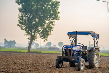 New tractor standing at agriculture field. modern farming concept.