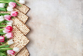 Obraz na płótnie Canvas Jewish holiday Passover celebration concept with matzah and tulip flowers on table