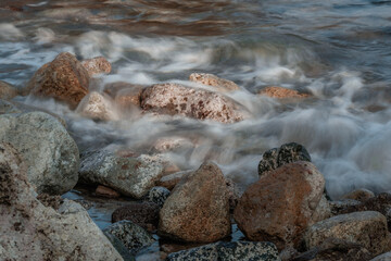 Long exposure close-up 121mm shot of ocean waves hitting the rocks