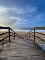 Fototapeta na wymiar A wooden boardwalk leads to the beach 