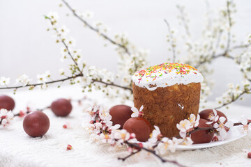 Easter background with colored eggs, colored easter eggs and blooming branches. Easter composition. Easter cake