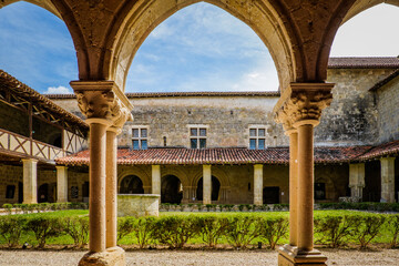 View on the arcades of the medieval cloister of the romanesque abby of Flaran in the south of...