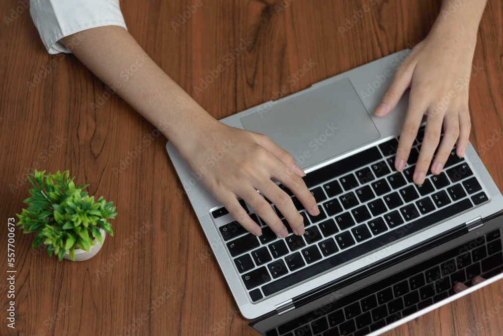 Aufkleber woman working and typing on the keyboard on table at home.top view