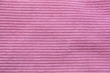 Closeup of pink corduroy cloth as patterned textured background