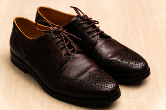Brown brushed leather shoe with broguing