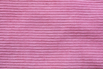 Closeup of pink corduroy cloth as patterned textured background