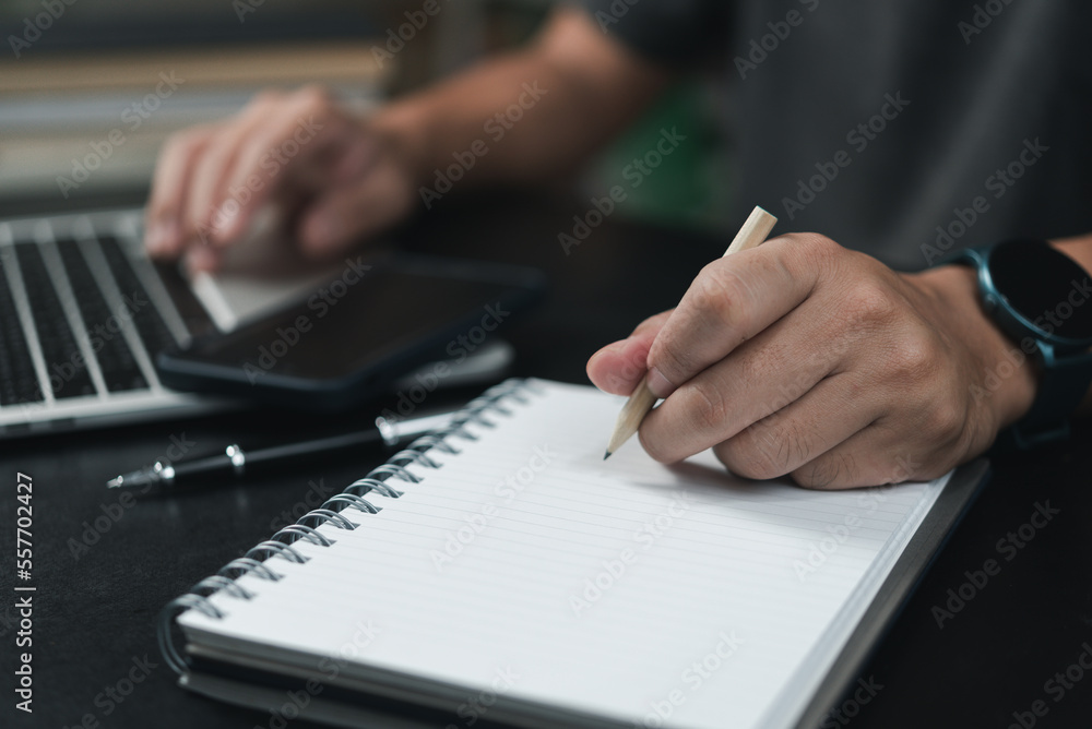 Aufkleber learning online class by using laptop computer and writing notebook at workplace, education developm
