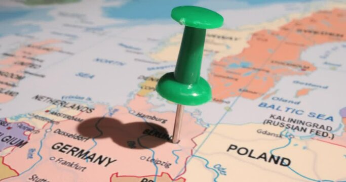Germany - Travel concept with green pushpin on the world map. The location point on the map points to Berlin, the capital of the German.