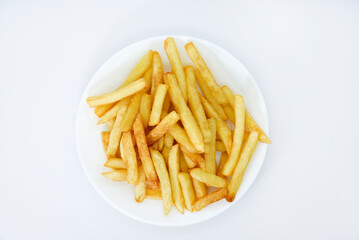 Yellow delicious French fries in white dishes. Fast food on a plate. Fried potatoes. Toasted potato slices on a white background.