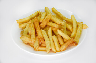 Yellow delicious French fries in white dishes. Fast food on a plate. Fried potatoes. Toasted potato slices on a white background.