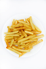 Yellow delicious French fries in white dishes. Fast food on a plate. Fried potatoes. Toasted potato slices on a white background.