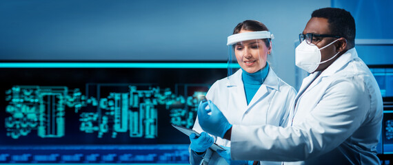 Group of microelectronic engineers discussing in a modern microprocessor manufacture lab. Workplace of electronics designers. The concept of innovations and inventions.