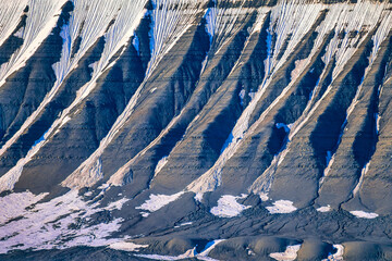 Eroded mountain slope with snow