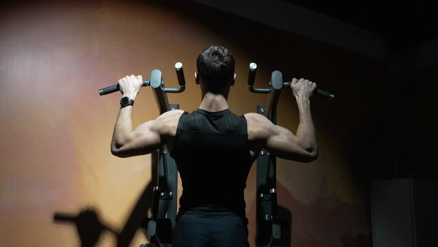 sportsman do pullup workout in sport gym, back view. sport sportsman with pullup in workout gym.