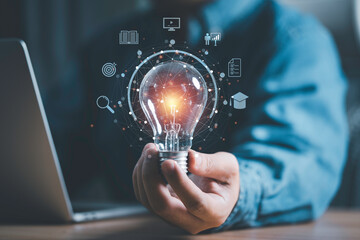 Businessman hand holding lightbulb with connection line and knowledge icon to creative smart thinking for inspiration and innovation with network concept.