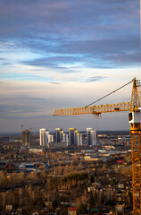 Naklejka premium Inside place for many tall buildings under construction and cranes under a blue sky