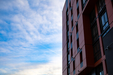 Bottom up view on new modern residential buildings made of red and yellow brick. Medium-rise residential building.