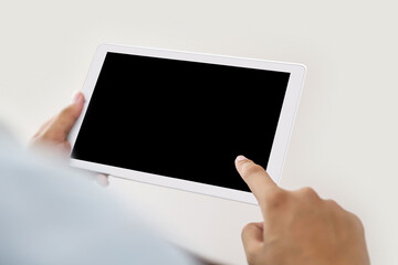 Hand holding blank screen phone or smartphone or tablet for template