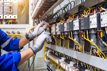 Electricity or electrical maintenance service, Engineer hand checking electric current voltage at...