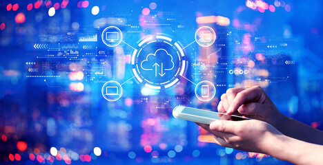 Cloud computing with person using a smartphone in a city at night