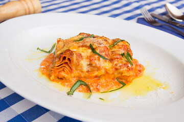 Lasagna is a type of pasta. It is usually served in overlapping sheets interspersed with layers of ingredients to taste, most often meat in bolognese sauce and béchamel.